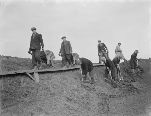Workers increasing the river defences and doing repairs on the river wall and embankment