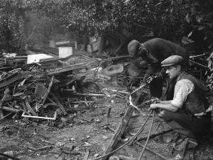 Debris Prints: Workmen clearing up metal dumped in an orchard in St Mary Cray, Kent