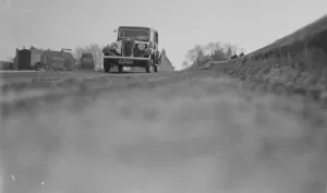 Maintenance Prints: Workmen lay the foundations for road banking along the edges of the road in Farningham