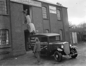 Workmen loading up a delivery van from Platt Mill, Borough Green, Kent with sacks