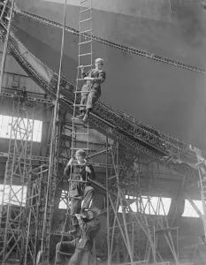 Worlds largest airship for the United States Girl workers on the airship climbing