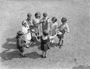 A five - year - old conductor at Crystal Palace Music Festival. Boys and girls