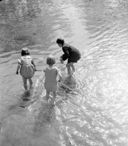 Playing Prints: Young children paddle in the ford by the Eynsford humpback bridge over the River