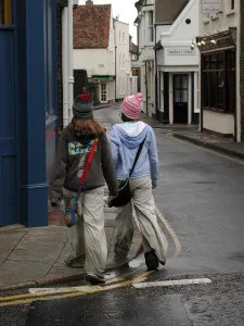 Eccentric Prints: Young fashion: two teenage girls wearing baggy trousers that drag on the ground and get dirty