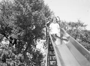 Playing Prints: A young girl on a slide in Dartford, Kent. 1939