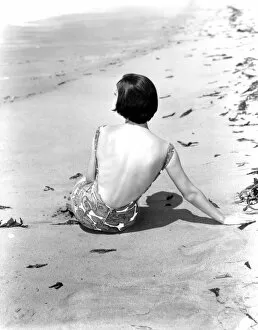 Summer Collection: A young woman relaxing on the beach April 1953