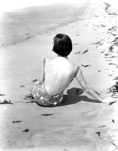 Pictorial Press Prints: A young woman relaxing on the beach April 1953