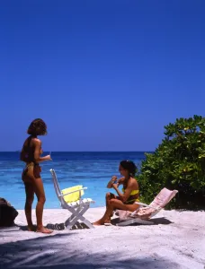 Sunbathing Prints: Two young women on the beach of Bandos Island, the Maldives
